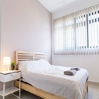 Une chambre à coucher avec le mur et des accessoires de couleur blanche et un lit en bois